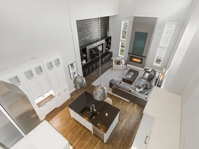 Bright, modern living room with HUGE ceilings. Abundant natural light, plush seating for everyone, a cozy gas fireplace, and a Smart TV_perfect for relaxing.