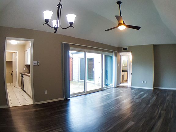 Living/Dining: The focal point of your home. Features: Vaulted Ceiling. Newly replaced patio doors and windows with screens. Remote-controlled ceiling fan. Chandelier with LED bulbs. USB outlet.