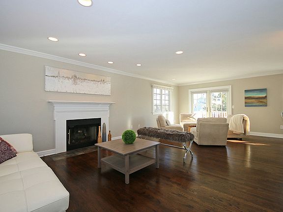 Living room with fireplace and french doors to deck