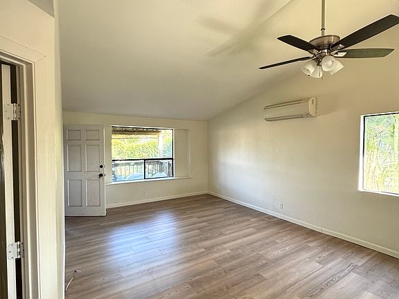 Living room with split duct AC, new flooring, new paint, new fan