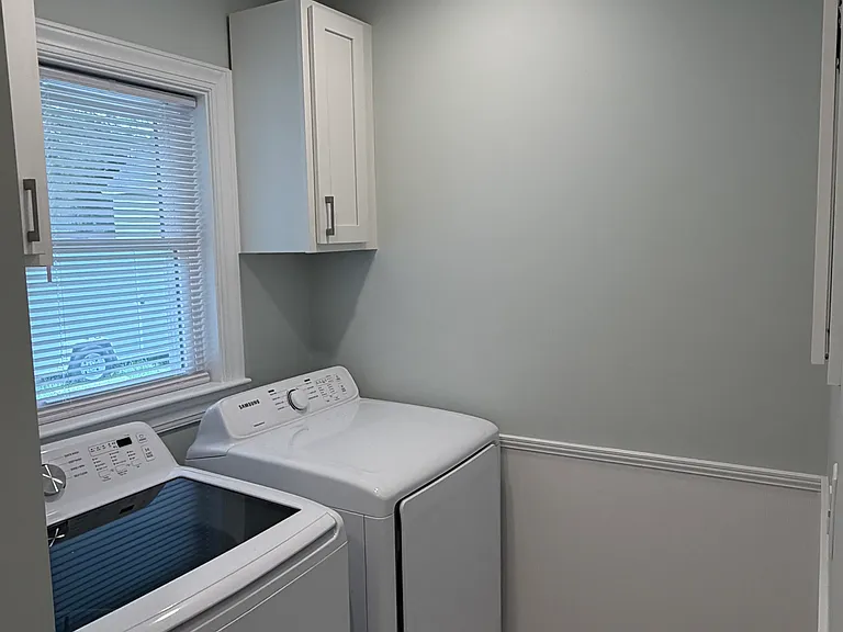 Laundry room off guest bathroom.