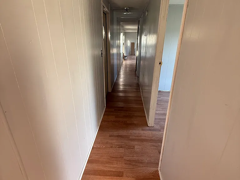 Hallway looking out from the third bedroom. Second bedroom on the right.