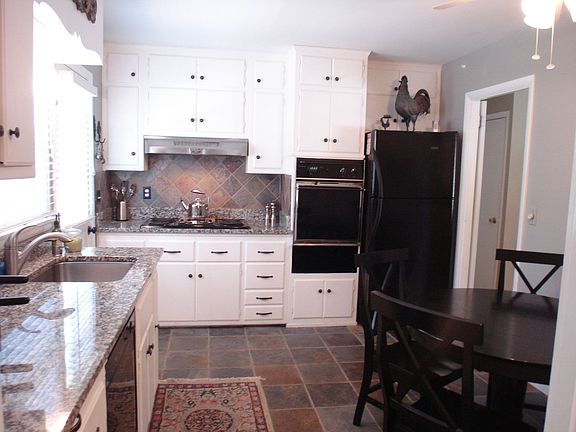 Kit has granite counters & slate fls & backsplash