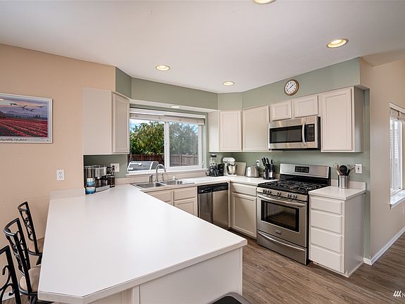 Kitchen features upgraded stainless steel appliances. Kitchen window overlooks the backyard.>