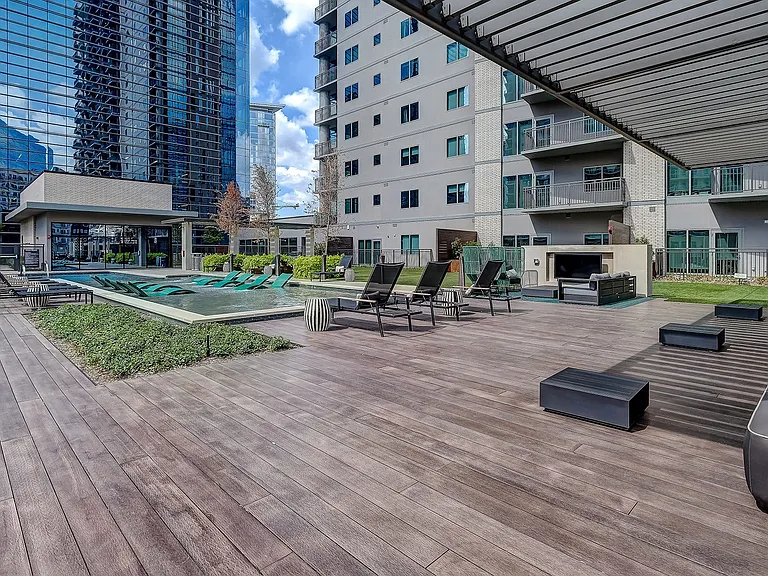 Resort Style Swimming Pool with Cabanas, Lounge Spaces, and City Views