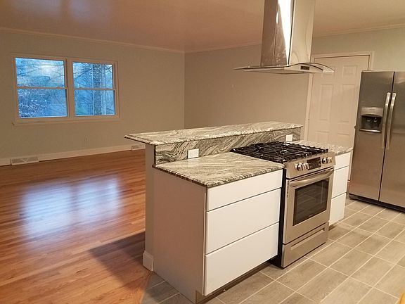 Granite countertop center island with vented pendant exhaust