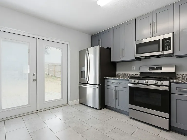 Kitchen with all stainless steel appliances, gas range, soft close cabinets & granite counter tops