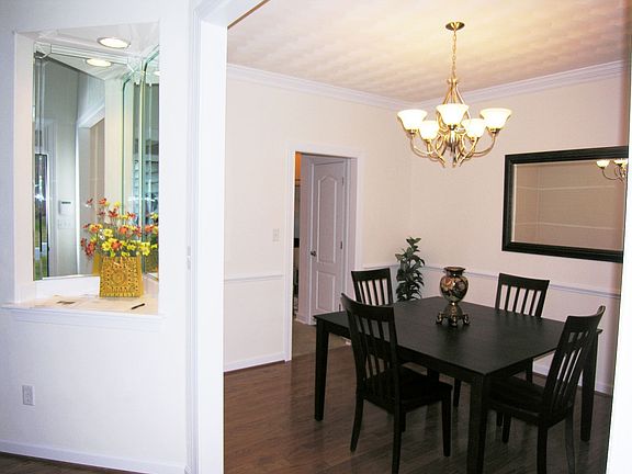 Front entrance and dining room with hardwood floors