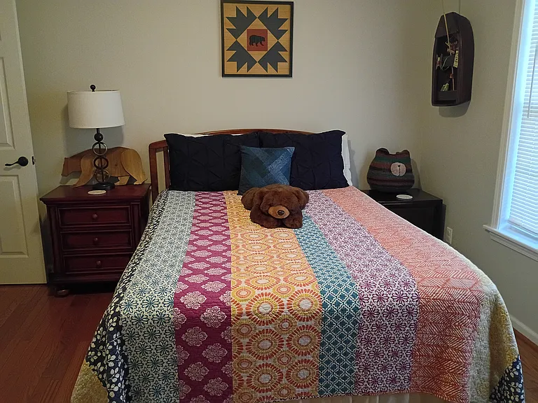 The third bedroom, known as the "Bear Room," features a queen-size bed and a chest of drawers.