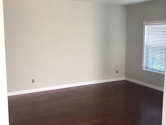 Large Bright and airy living room with open floor plan to dining area and kitchen. Engineered wood flooring through the first floor
