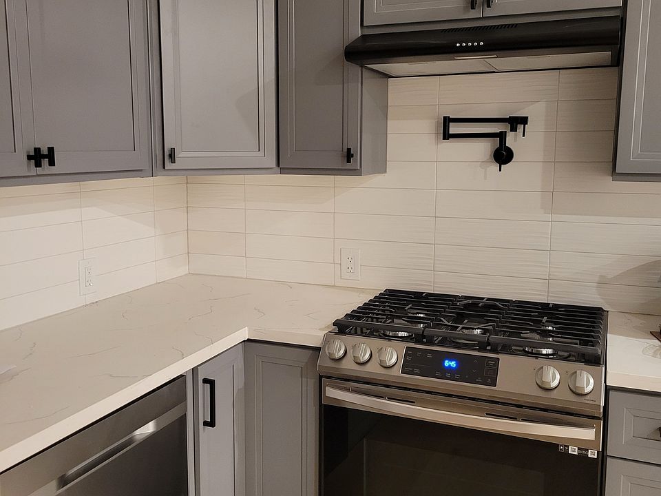 Kitchen with dishwasher, gas stove with pot filler