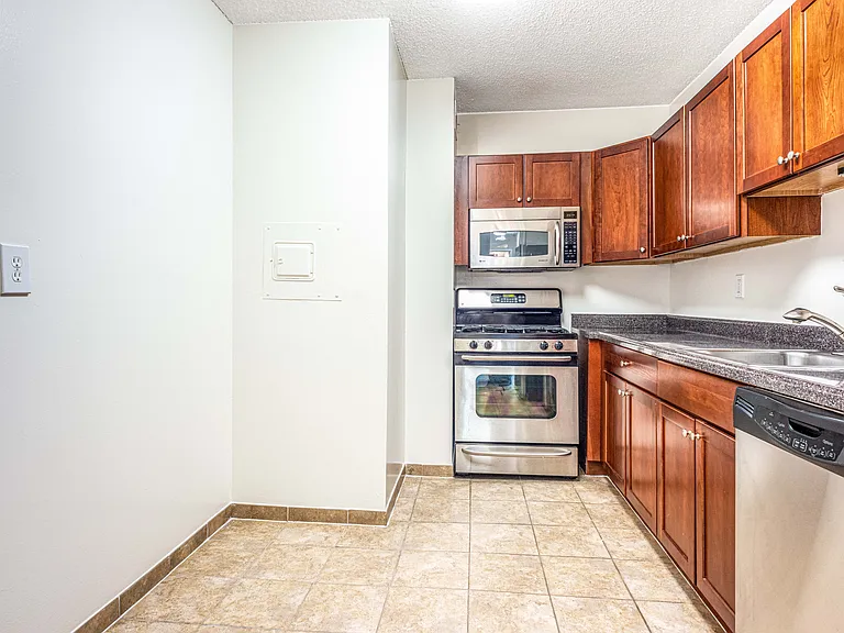 Updated kitchens with stainless steel appliances, cherry maple cabinets and gas range