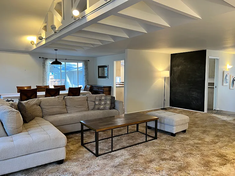 Living room features a chalkboard wall, perfect for drawing, notes, and creativity.