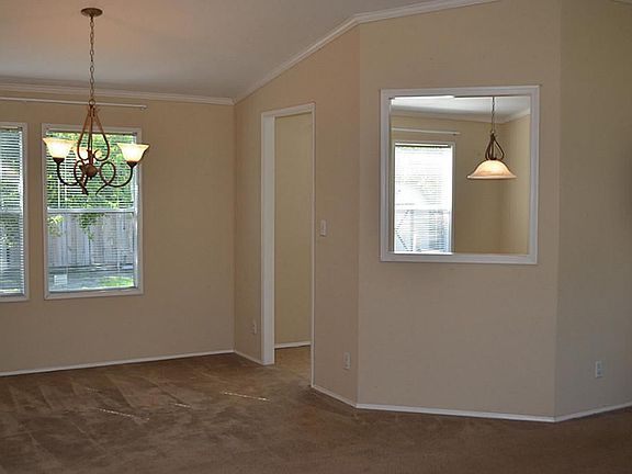 The dining room with newer chandelier overlooks the breakfast area and kitchen.