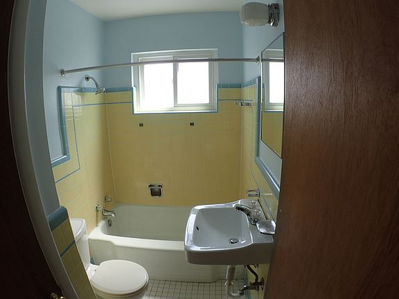 Original mid-century bathroom tiles with new fixtures.