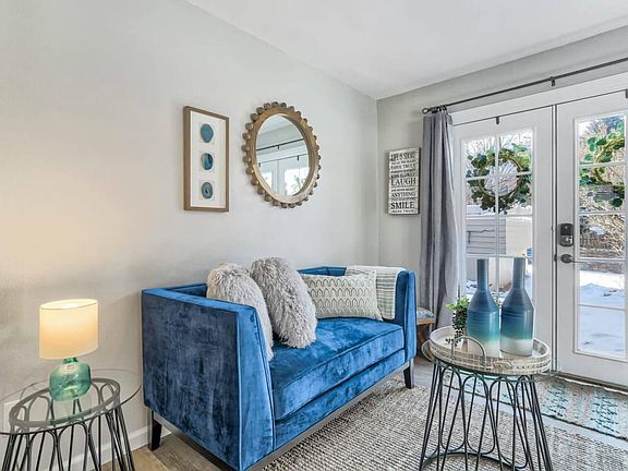 A plush, cerulean blue sofa, with lots of throw pillows, invites you to curl up and relax with a good book or an old movie. Such a sweet setting with a cozy, quaint and multi-cultural feel.