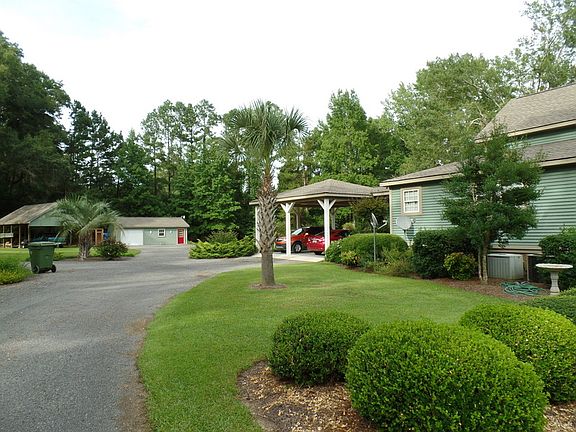 Driveway goes to the carport and the to the back of the house to the garage.