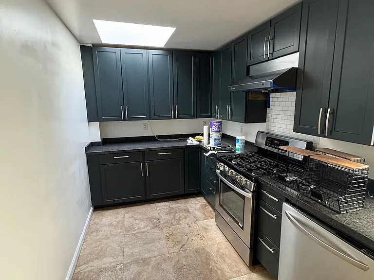 Kitchen w/ stove, range hood, dishwasher, garbage disposal, fridge & freezer