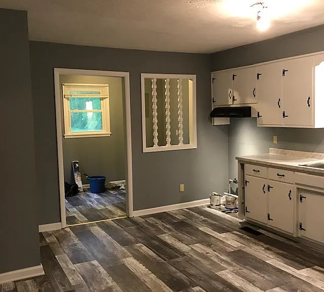 Kitchen. Electric stove hood & vent. Doorway to utility room with window.