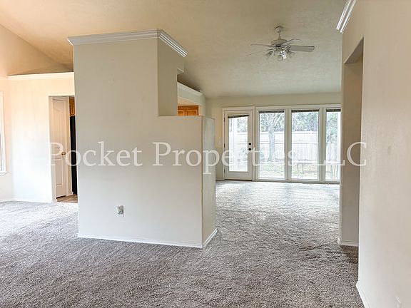 Living room off of kitchen with direct access to backyard.