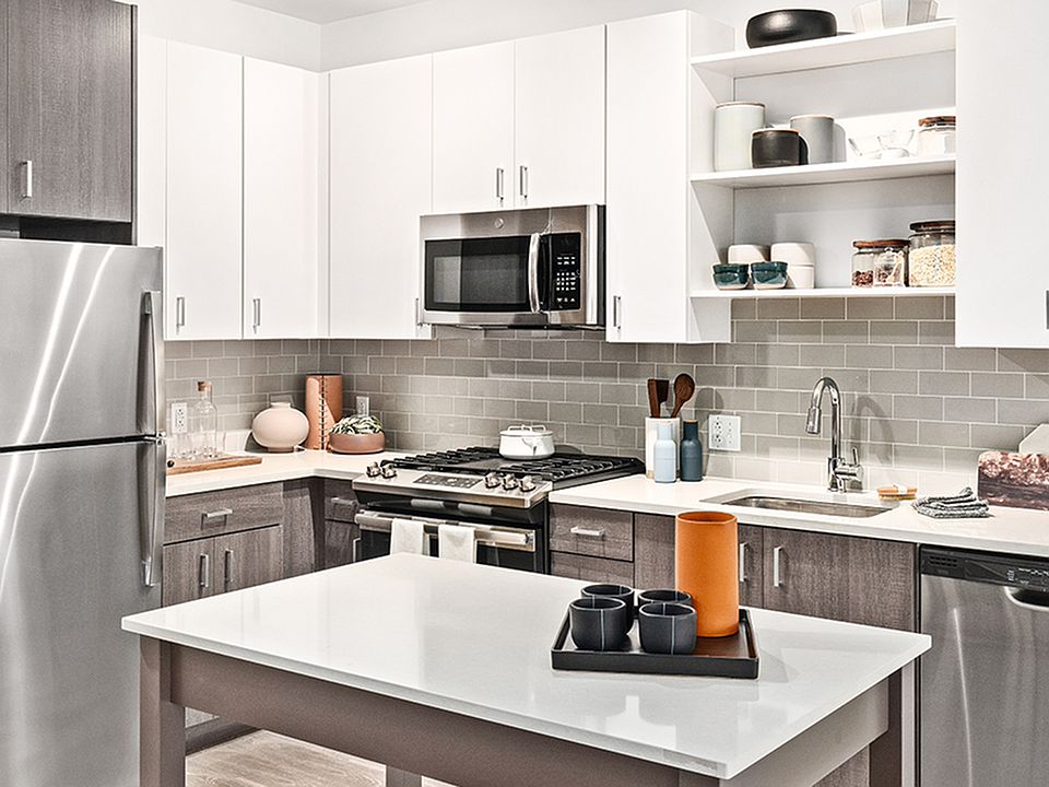 Beautifully equipped kitchens with stunning white cabinetry with chrome pulls and stainless steel appliances