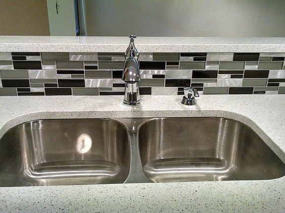 Quartz countertop, glass backsplash