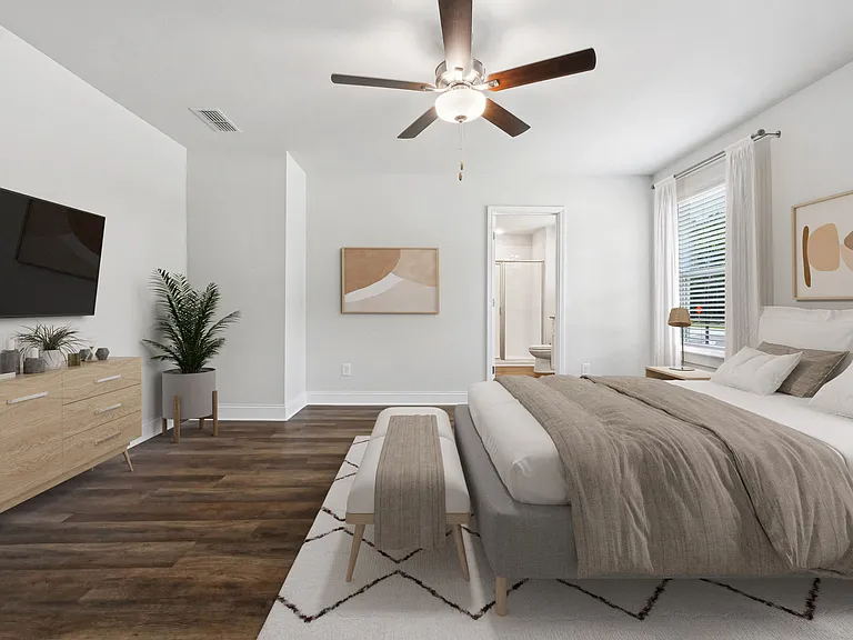 Spacious primary bedroom with a king bed and abundant natural light.