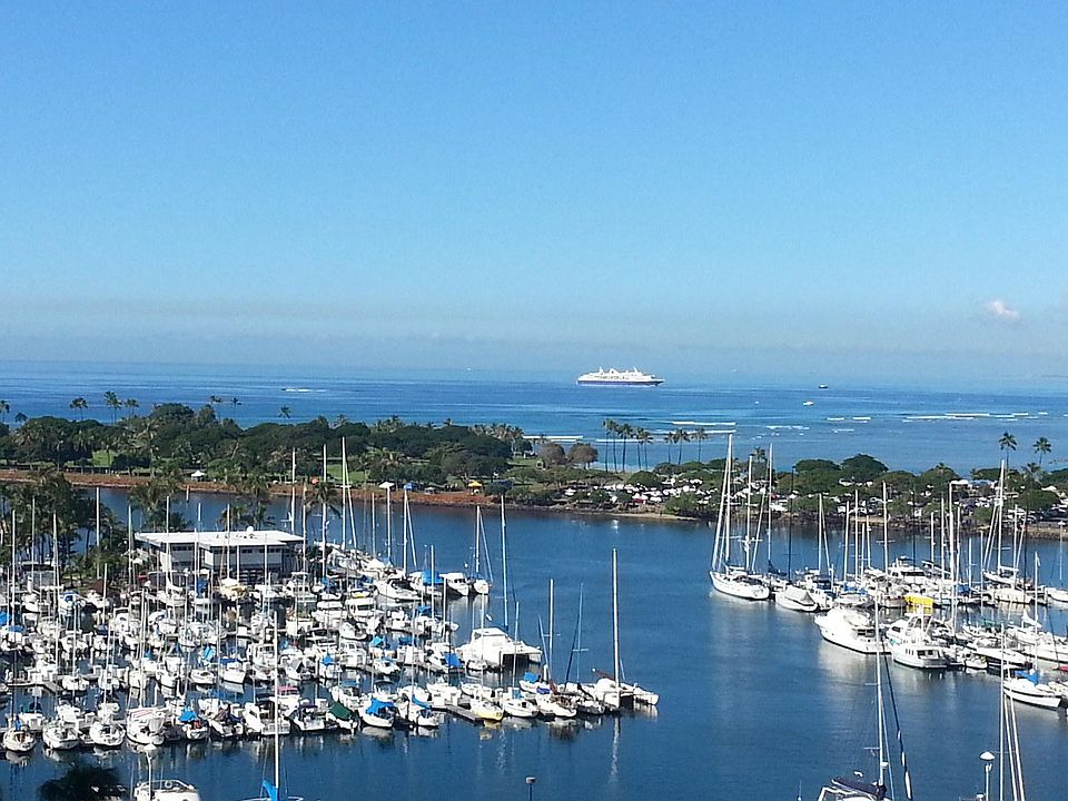 Yacht harbor and Pacific Ocean from the lanai. Magic Island and Ala Moana Beach Park in middle ground.