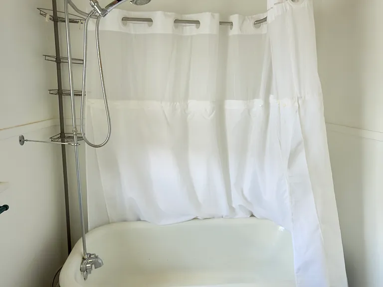 detail of clawfoot tub in upstairs bathroom
