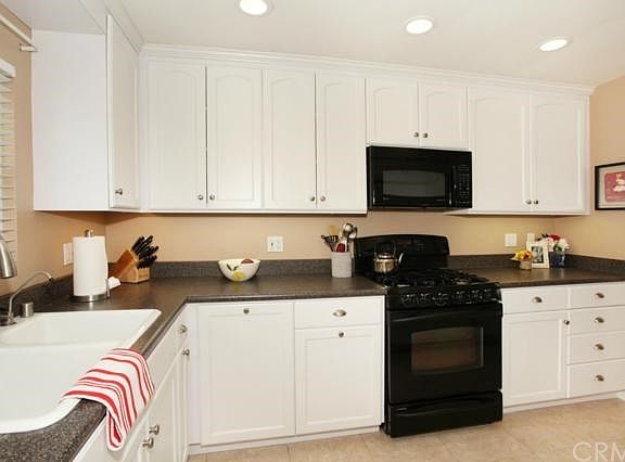 Gas Range & Built In Microwave, Under Cabinet Lighting, Recessed Lighting and a View to the Backyard