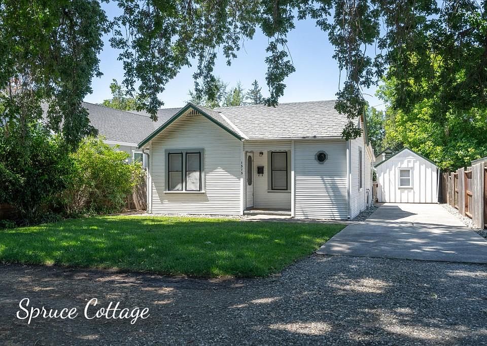 Front yard and front of house. Off street parking in driveway to the right of the house. Laundry building at end of driveway.