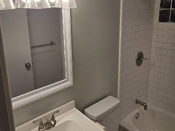Remodeled Bathroom; Replaced everything from Top Down; Vanity, Light, Medicine Cabinet, Toilet, Tile Flooring, Tub, Faucets, Shower Curtain Rod, etc.
