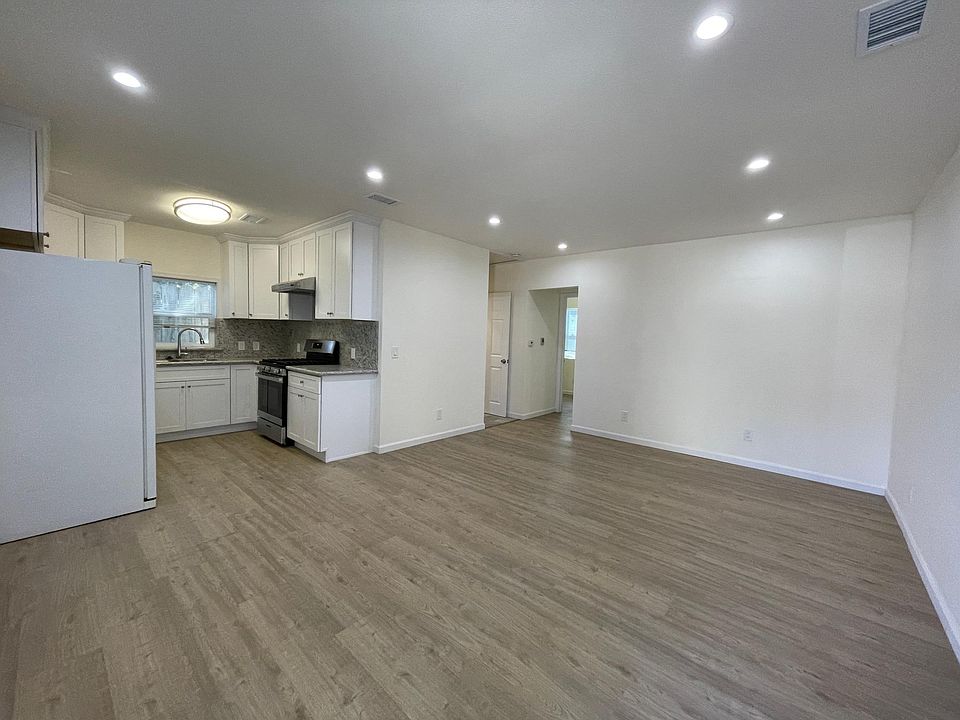 Living room with new flooring and bright recessed lighting