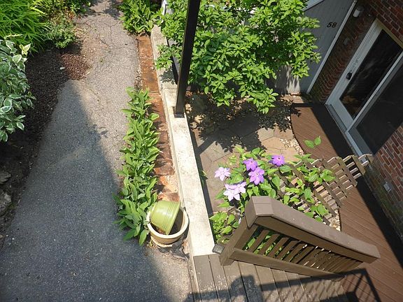 Rear patio entrance from walkway that leads to private parki