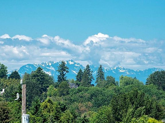 Olympic Mountains sprinkled with traces of spring snow from the off street parking pad.