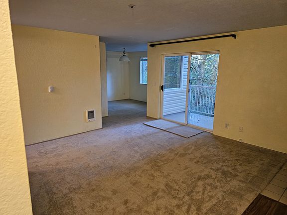 Living room view from entrance to dining area and balcony door
