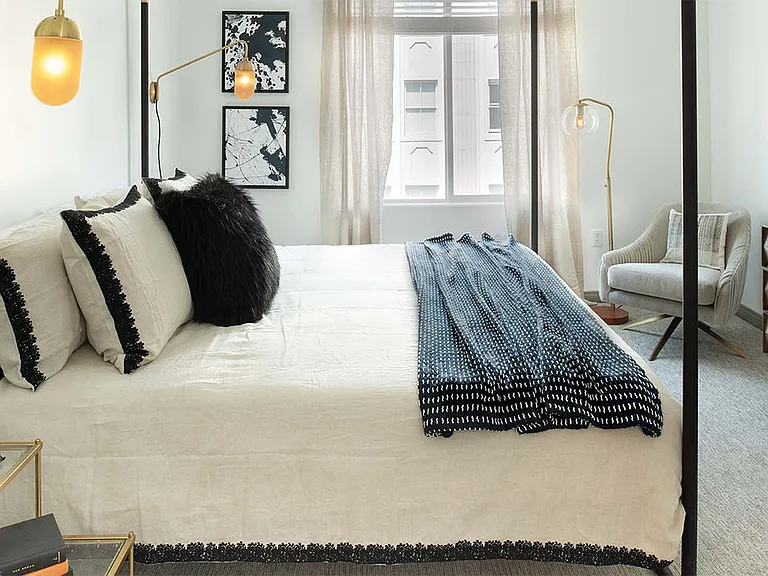 Spacious apartment bedroom with carpeted floors.
