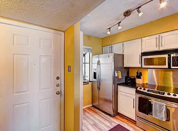 Gorgeous stainless steel appliances and solid surface counters