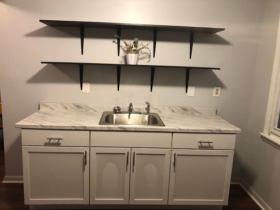 Spacious kitchen with brand new cabinetry and shelving, modern appliances.
