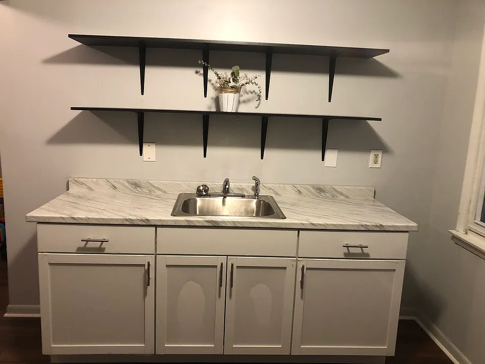 Spacious kitchen with brand new cabinetry and shelving, modern appliances.