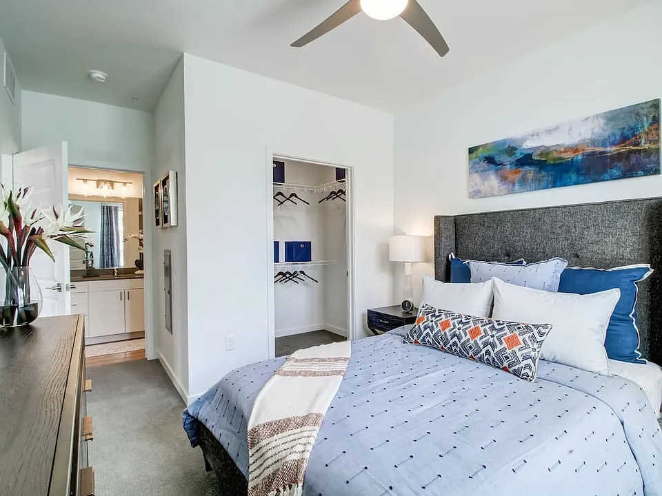Bedroom with ceiling fan and carpeted flooring
