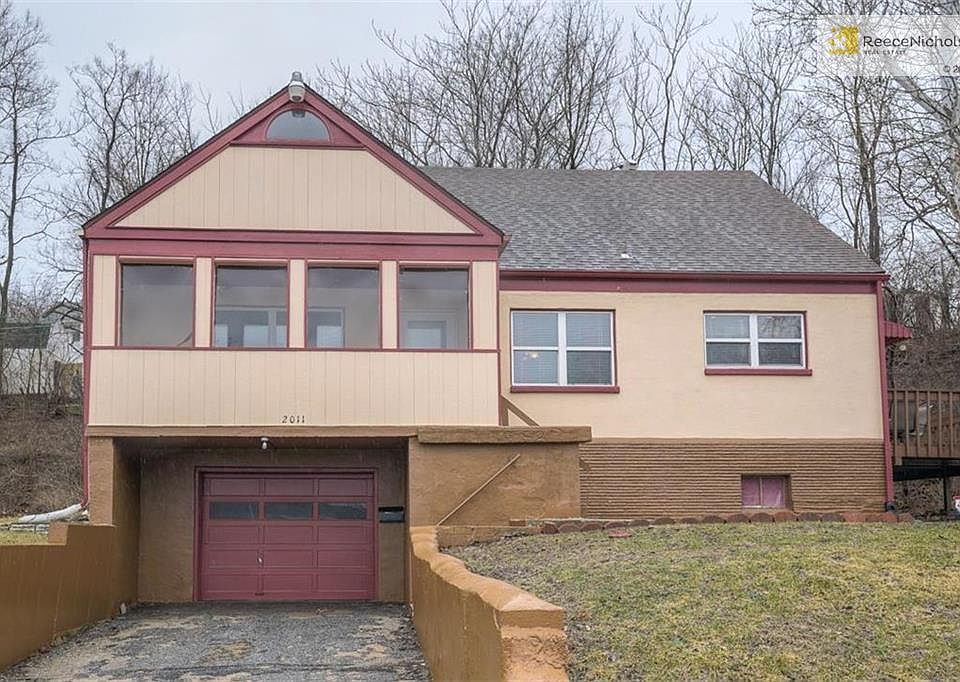 Front of home with secured parking and enclosed entry