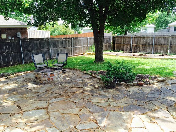 Back yard stone patio w/firepit and garden