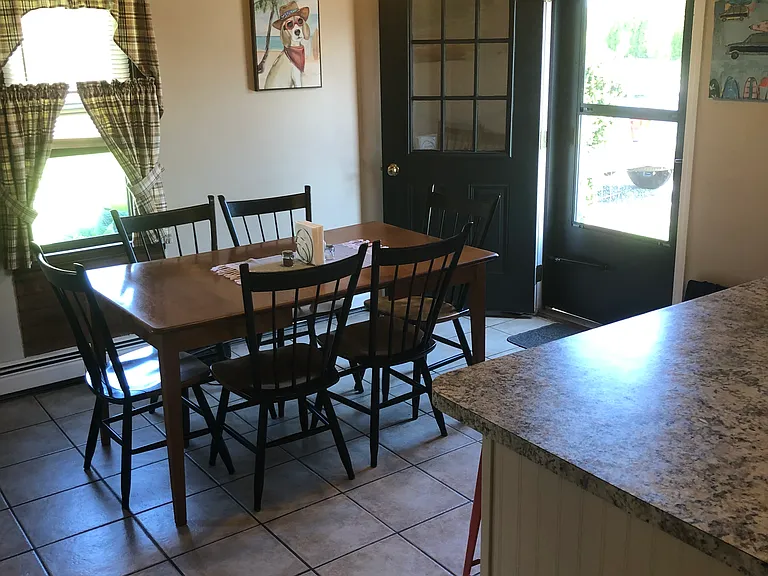 Dining and kitchen; door to side deck
