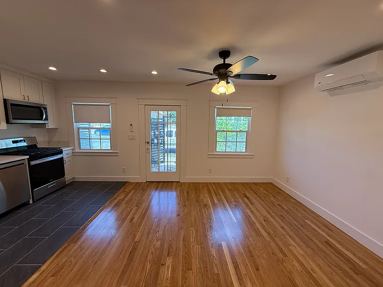 HUGE LIVING ROOM WITH NEWLY INSTALLED WHITE OAK HARDWOOD FLOORS, CEILING FAN AND CENTRAL MINI-SPLIT AIR