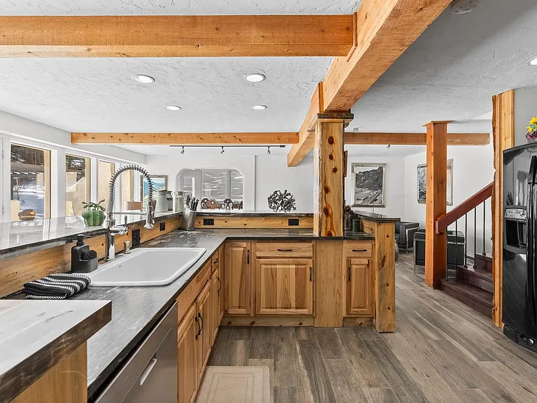Large kitchen equipped with appliances and a countertop bar