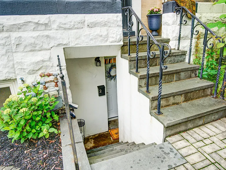 Just steps down from your patio, you'll find the private entrance to this inviting lower-level apartment, offering both convenience and a sense of seclusion.