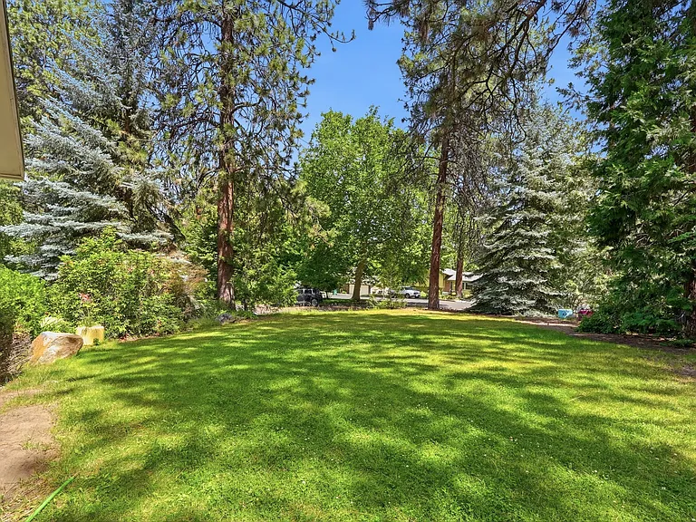 large lawn on east side against garage provides ample room for family fun and party games