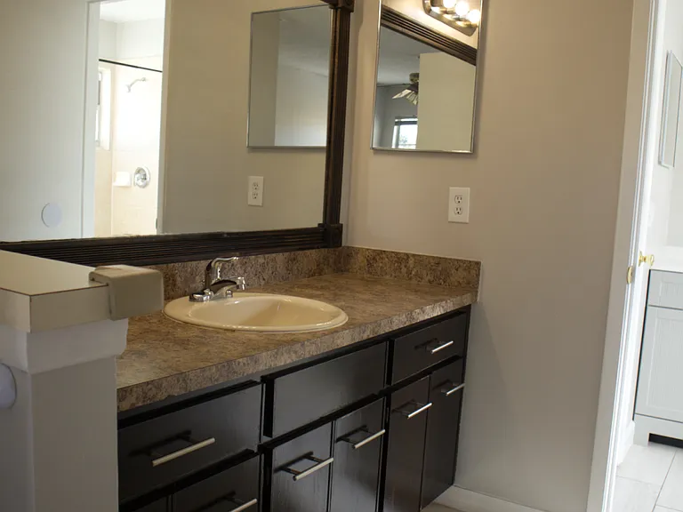 Master Bedroom, sink with vanity and passthrough door to bathroom.
