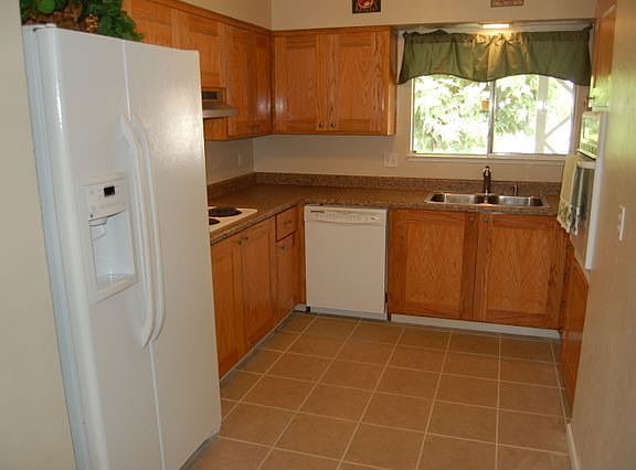 Bright clean kitchen, custom oak cabinetry, new tile floor